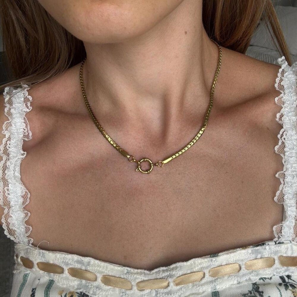 The Kya  gold stainless steel chain necklace front clasp closure herringbone